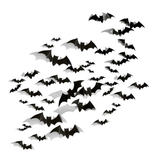 Black paper bat cutouts in various sizes arranged in flying pattern for Halloween decor.
