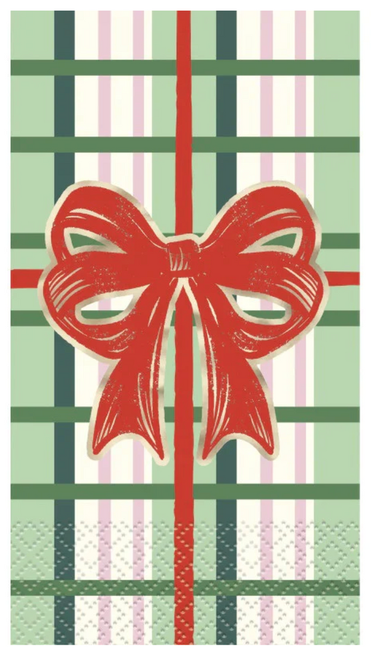 Green and white plaid napkin with red ribbon and bow design, vintage Christmas style.
