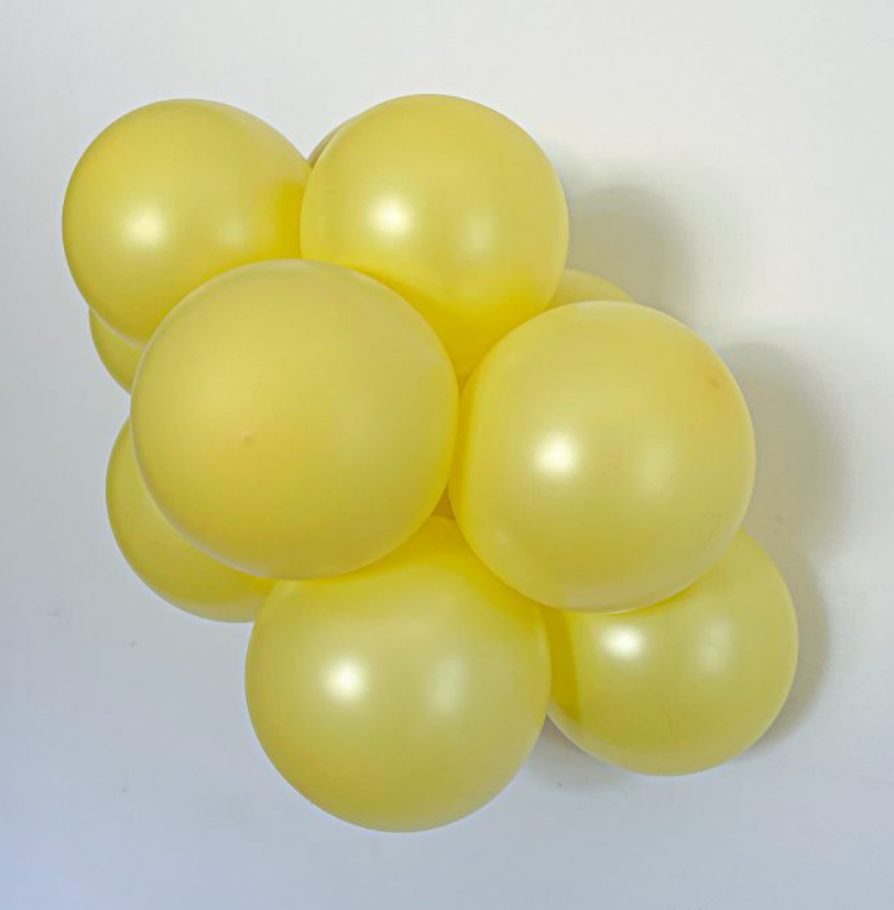 Cluster of glossy pearlized yellow 11-inch latex balloons with a smooth, shiny finish.