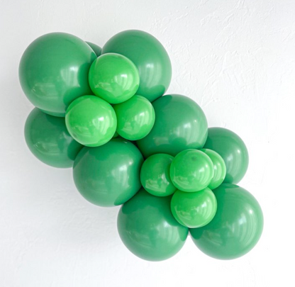 Cluster of shiny green latex balloons in varying sizes, arranged in a decorative bunch.