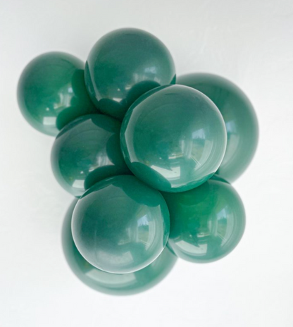 Cluster of glossy emerald green latex balloons inflated to a large 24-inch size.