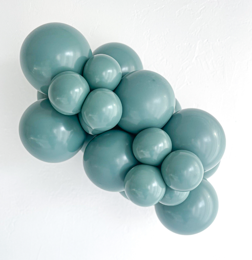 Cluster of teal balloons on a white background