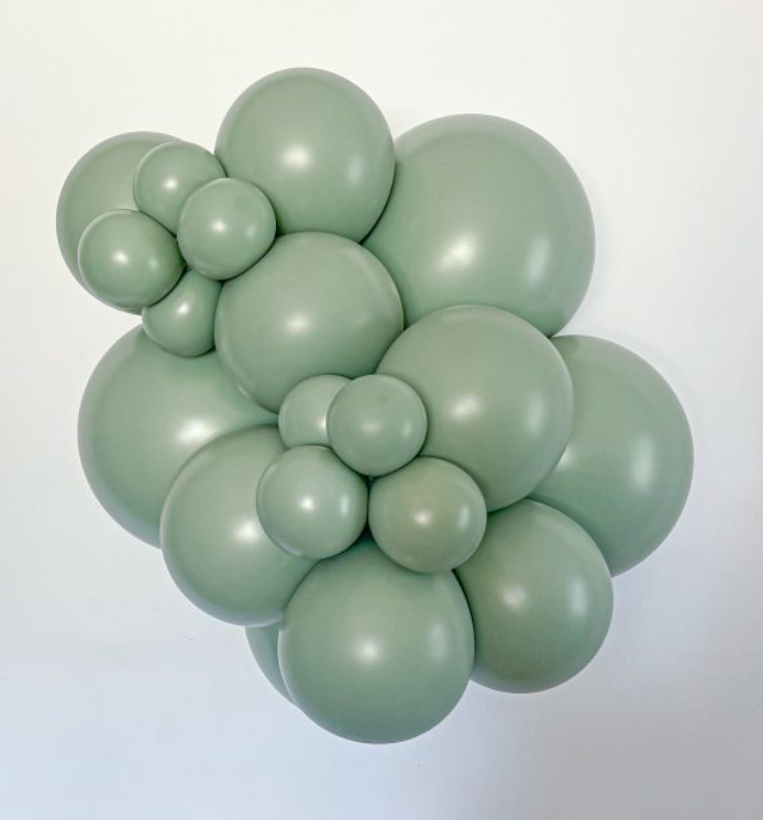 Cluster of matte sage green latex balloons in various sizes forming floral shapes.