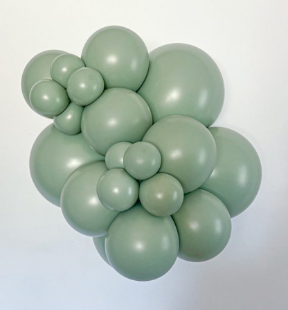 Cluster of matte sage green latex balloons in various sizes forming floral shapes.