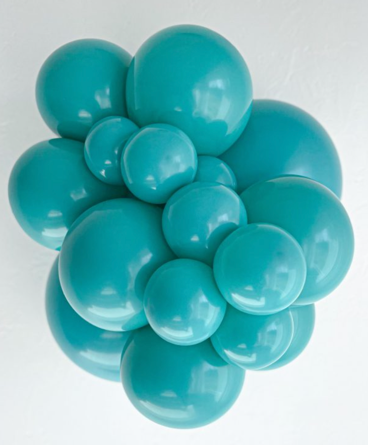 Cluster of shiny teal latex balloons in various sizes, glossy surface, round shape.