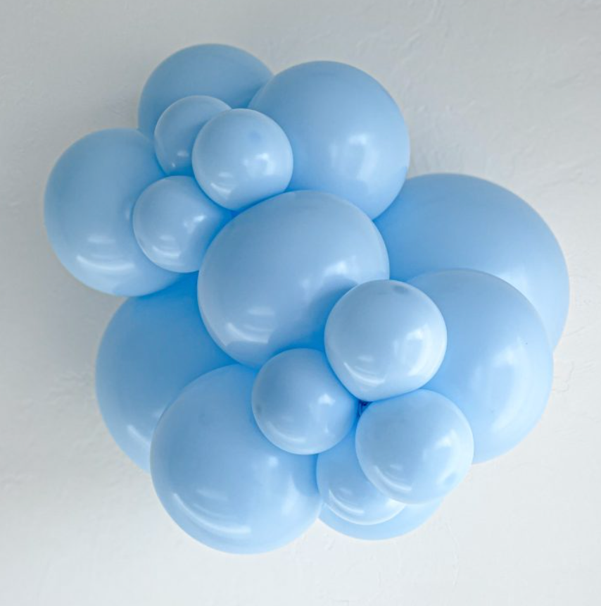 Cluster of light blue 5-inch latex balloons in varying sizes tightly grouped together.