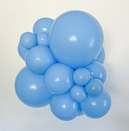 Cluster of glossy baby blue latex balloons in various sizes, inflated and arranged closely together.