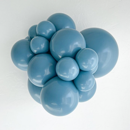 Cluster of glossy blue slate latex balloons in various sizes inflated together.
