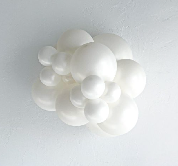 Cluster of matte white latex balloons in various sizes forming a decorative arrangement.