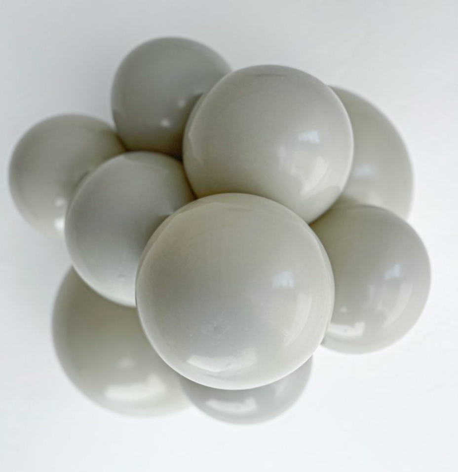 Cluster of smooth, round, stone gray latex balloons with a glossy finish.