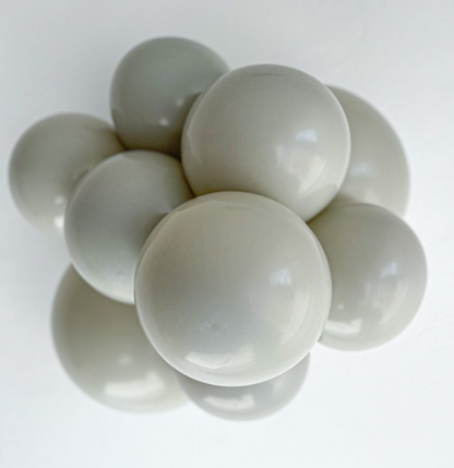 Cluster of smooth, round, stone gray latex balloons with a glossy finish.