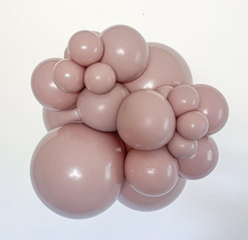 Cluster of matte malted brown latex balloons in various sizes, inflated and arranged tightly.