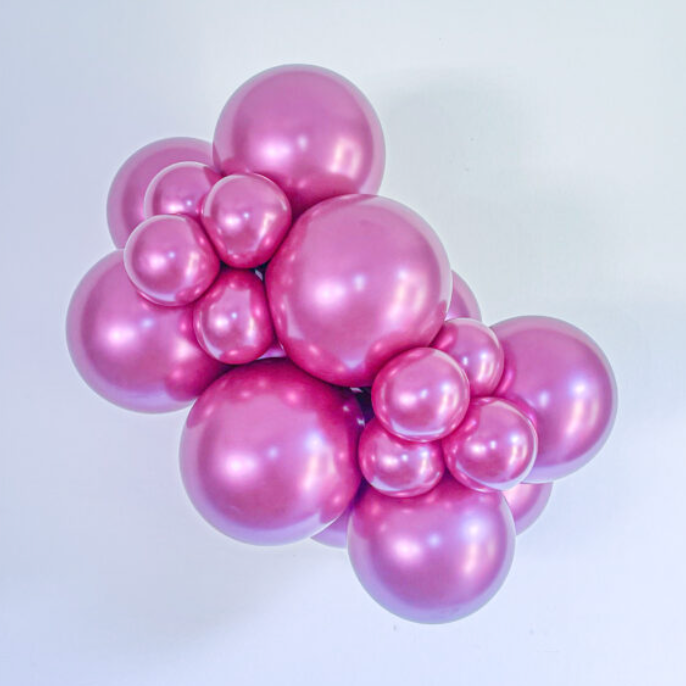 Cluster of shiny pink latex balloons in various sizes forming a decorative bunch.