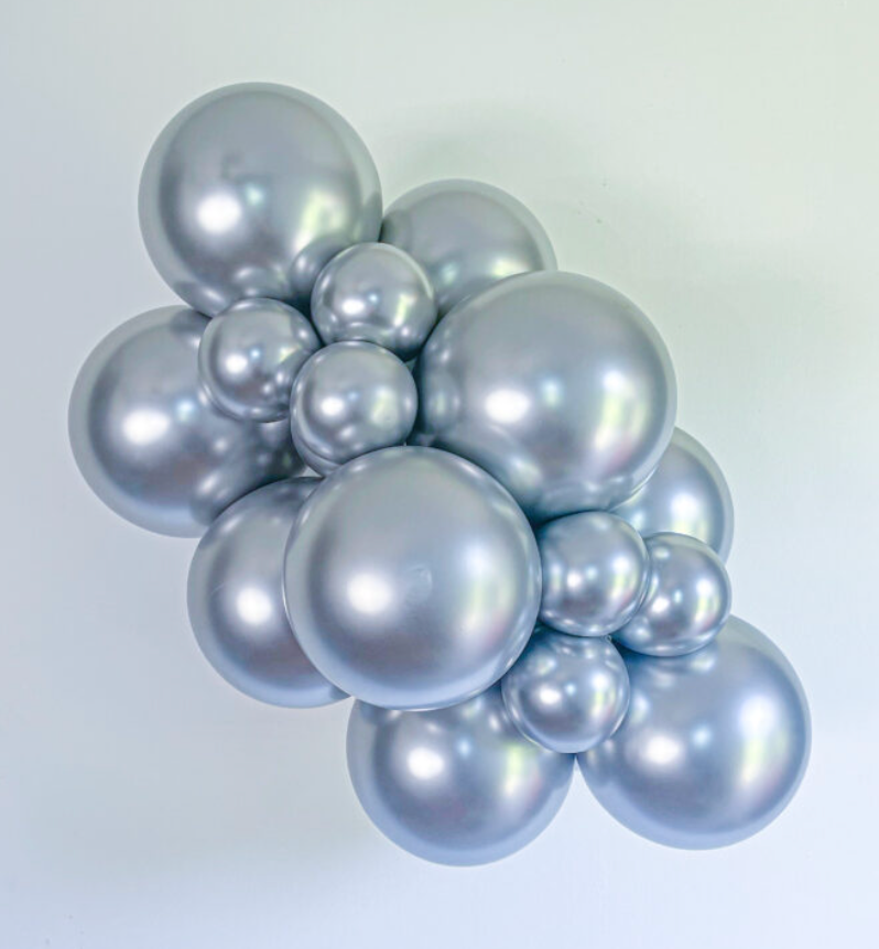 Cluster of shiny, silvery latex balloons in various sizes with an 11-inch diameter appearance.