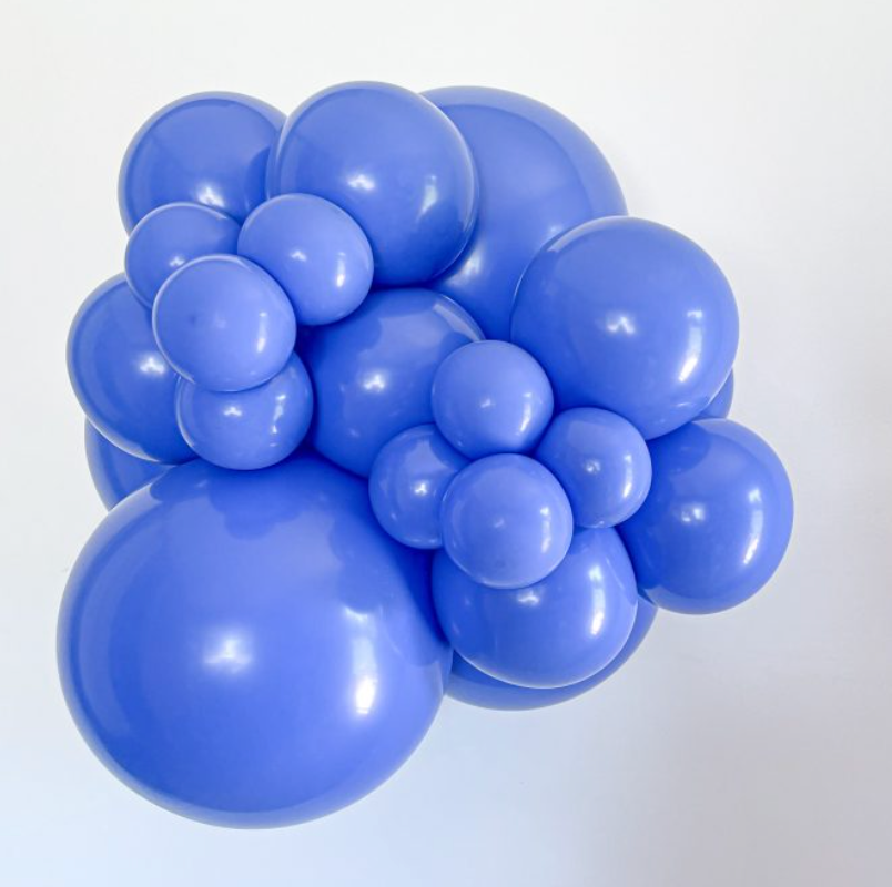 Cluster of shiny blue latex balloons in various sizes, inflated and grouped closely together.