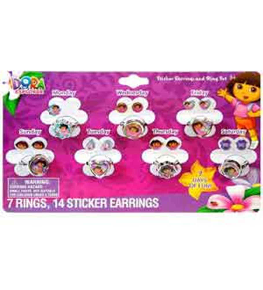 Set of seven colorful plastic rings and fourteen sticker earrings featuring Dora and friends, displayed on purple card with.