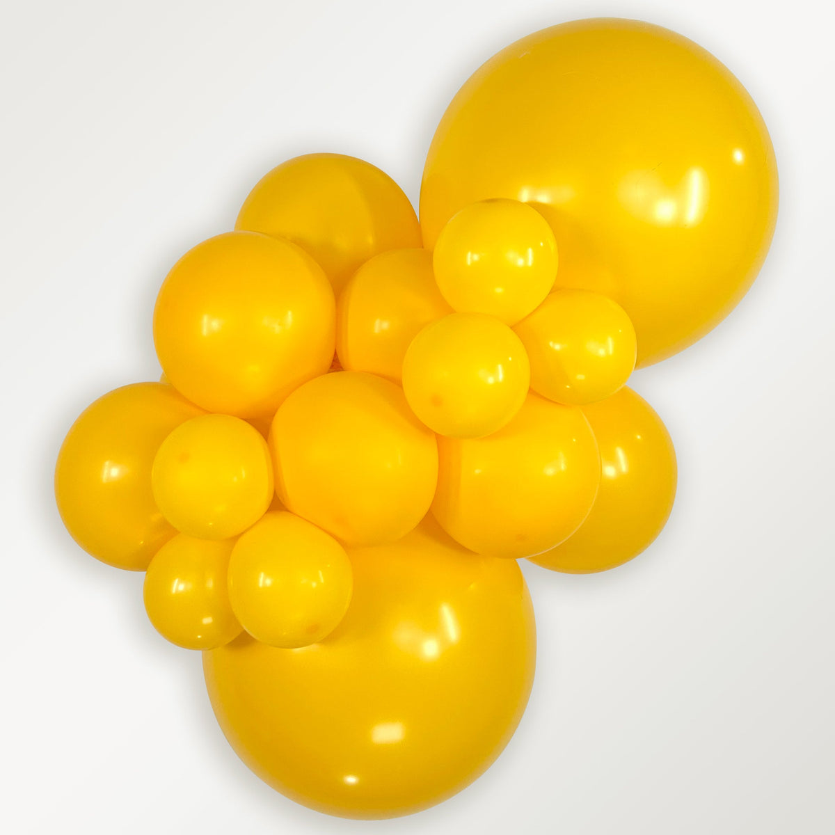 Sempertex Deluxe Honey Yellow latex balloon color cluster showing the shade across multiple balloon sizes