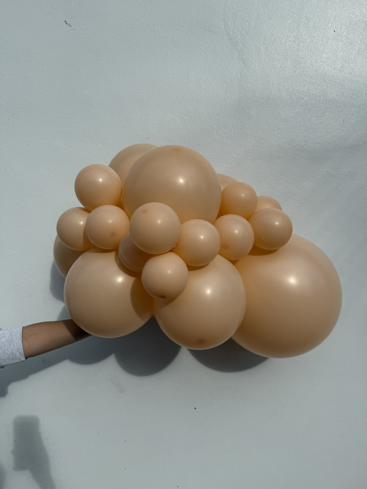 Sempertex Pastel Matte Nude latex balloon color cluster showing the shade across multiple balloon sizes