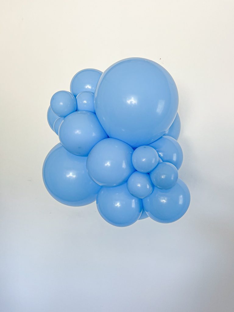 Tuftex Baby Blue latex balloon color cluster showing the shade across multiple balloon sizes