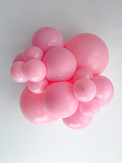 Tuftex Baby Pink latex balloon color cluster showing the shade across multiple balloon sizes