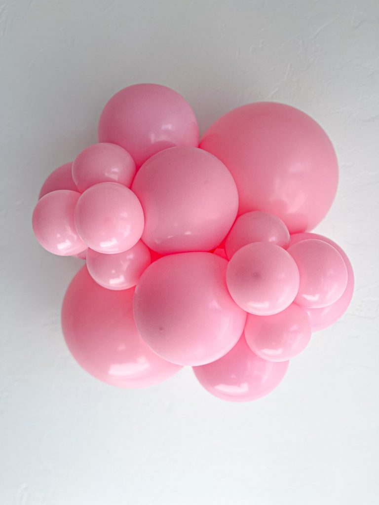 Tuftex Baby Pink latex balloon color cluster showing the shade across multiple balloon sizes