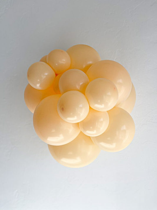Tuftex Blush latex balloon color cluster showing the shade across multiple balloon sizes