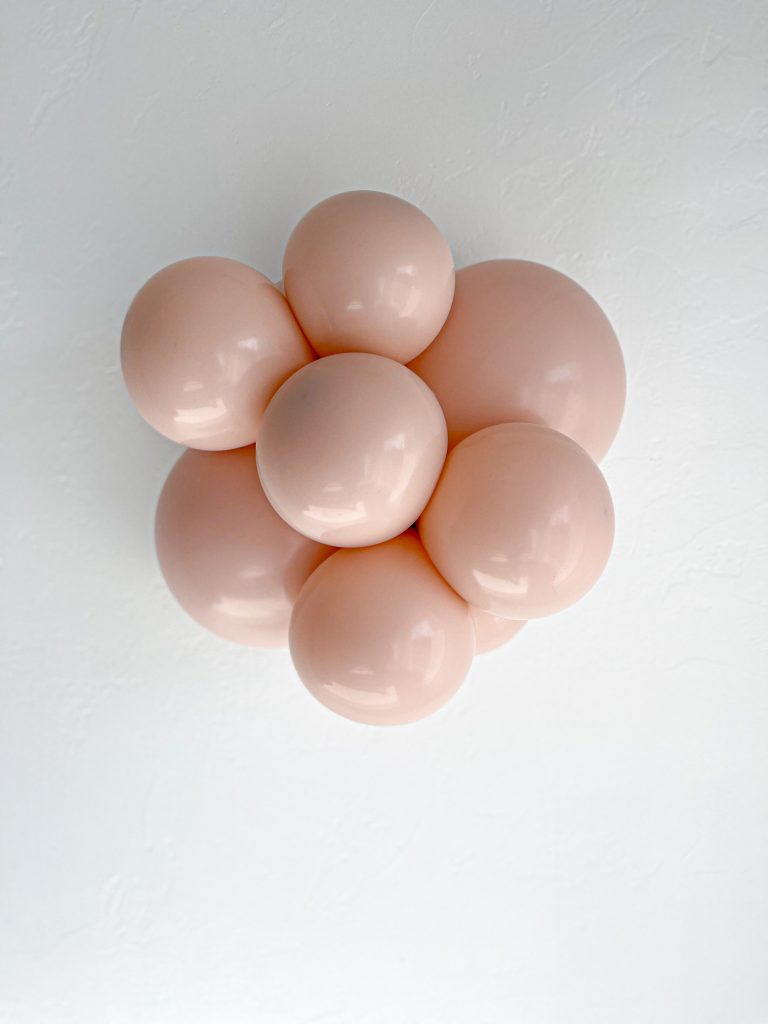 Tuftex Cameo latex balloon color cluster showing the shade across multiple balloon sizes