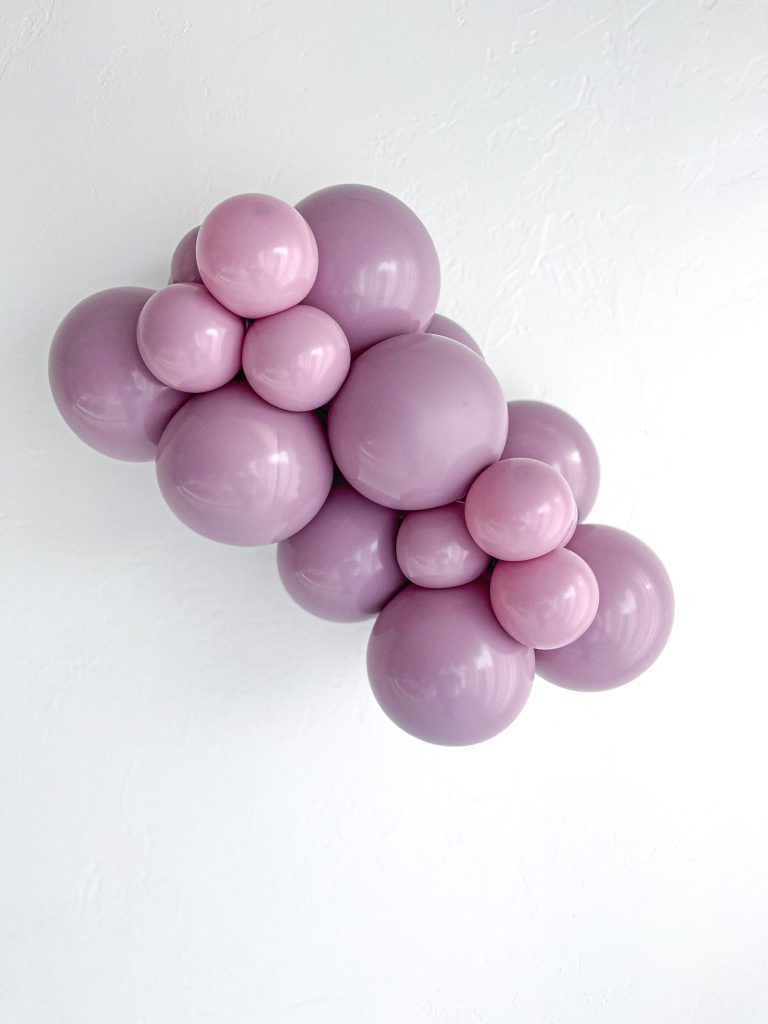 Tuftex Canyon Rose latex balloon color cluster showing the shade across multiple balloon sizes