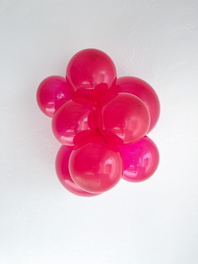 Tuftex Crystal Magenta latex balloon color cluster showing the shade across multiple balloon sizes