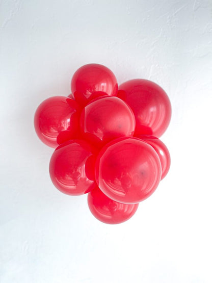 Tuftex Crystal Red latex balloon color cluster showing the shade across multiple balloon sizes