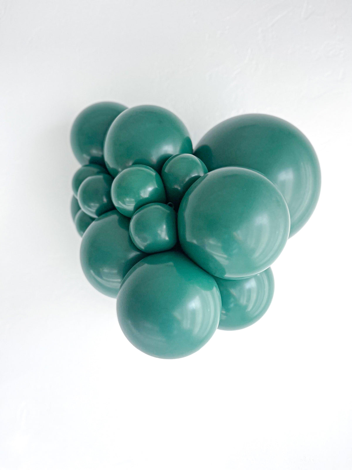 Tuftex Evergreen latex balloon color cluster showing the shade across multiple balloon sizes