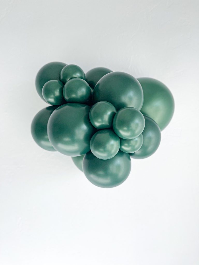 Tuftex Forest Green latex balloon color cluster showing the shade across multiple balloon sizes