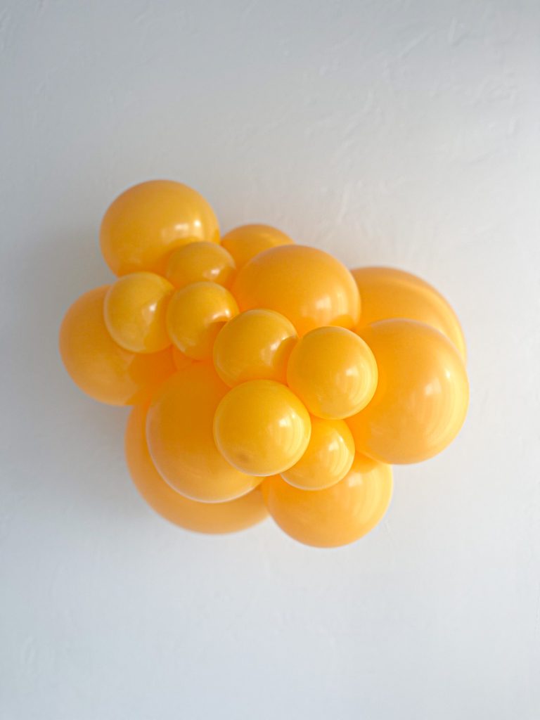 Tuftex Goldenrod latex balloon color cluster showing the shade across multiple balloon sizes