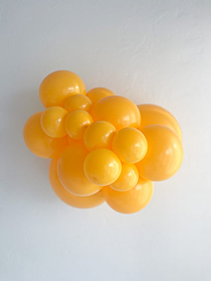 Tuftex Goldenrod latex balloon color cluster showing the shade across multiple balloon sizes