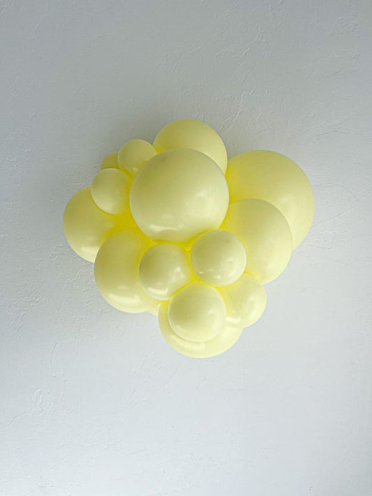 Tuftex Lemonade latex balloon color cluster showing the shade across multiple balloon sizes