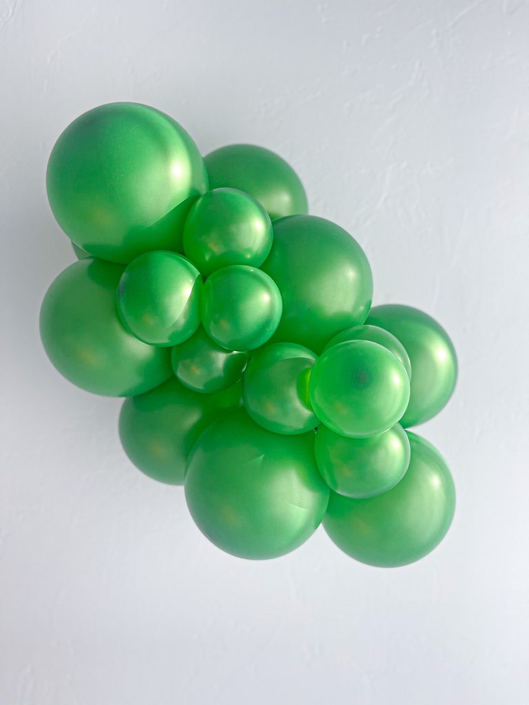 Tuftex Metallic Green latex balloon color cluster showing the shade across multiple balloon sizes