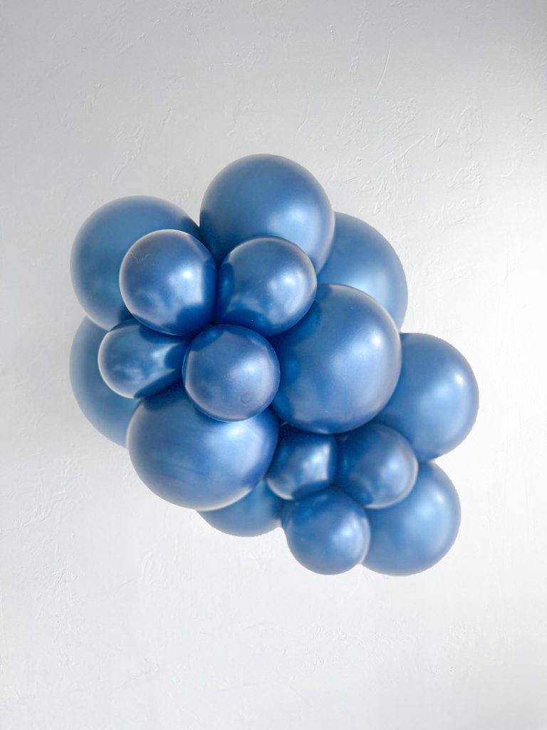 Tuftex Pearlized Midnight Blue latex balloon color cluster showing the shade across multiple balloon sizes