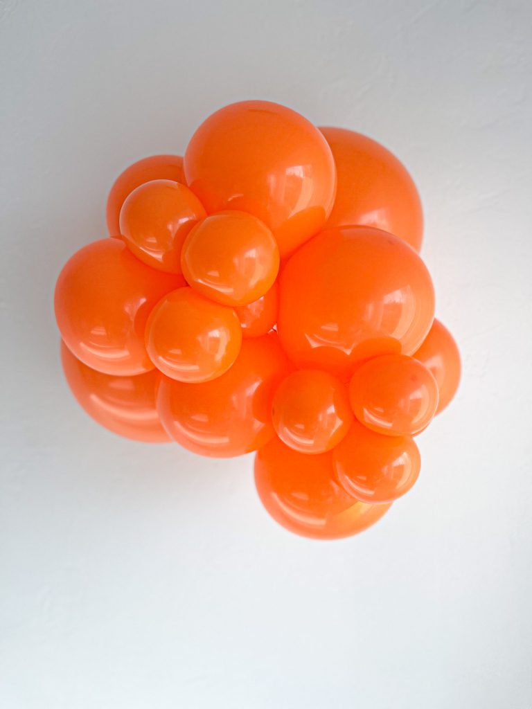 Tuftex Orange latex balloon color cluster showing the shade across multiple balloon sizes