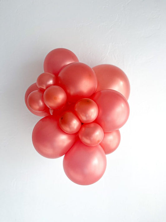 Tuftex Rose Gold latex balloon color cluster showing the shade across multiple balloon sizes