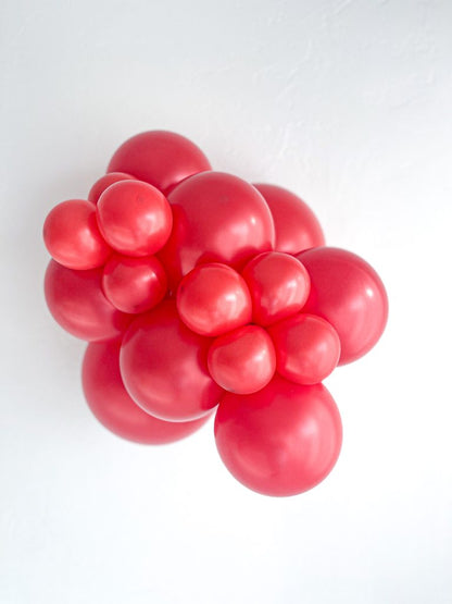 Tuftex Pearlized Starfire Red latex balloon color cluster showing the shade across multiple balloon sizes