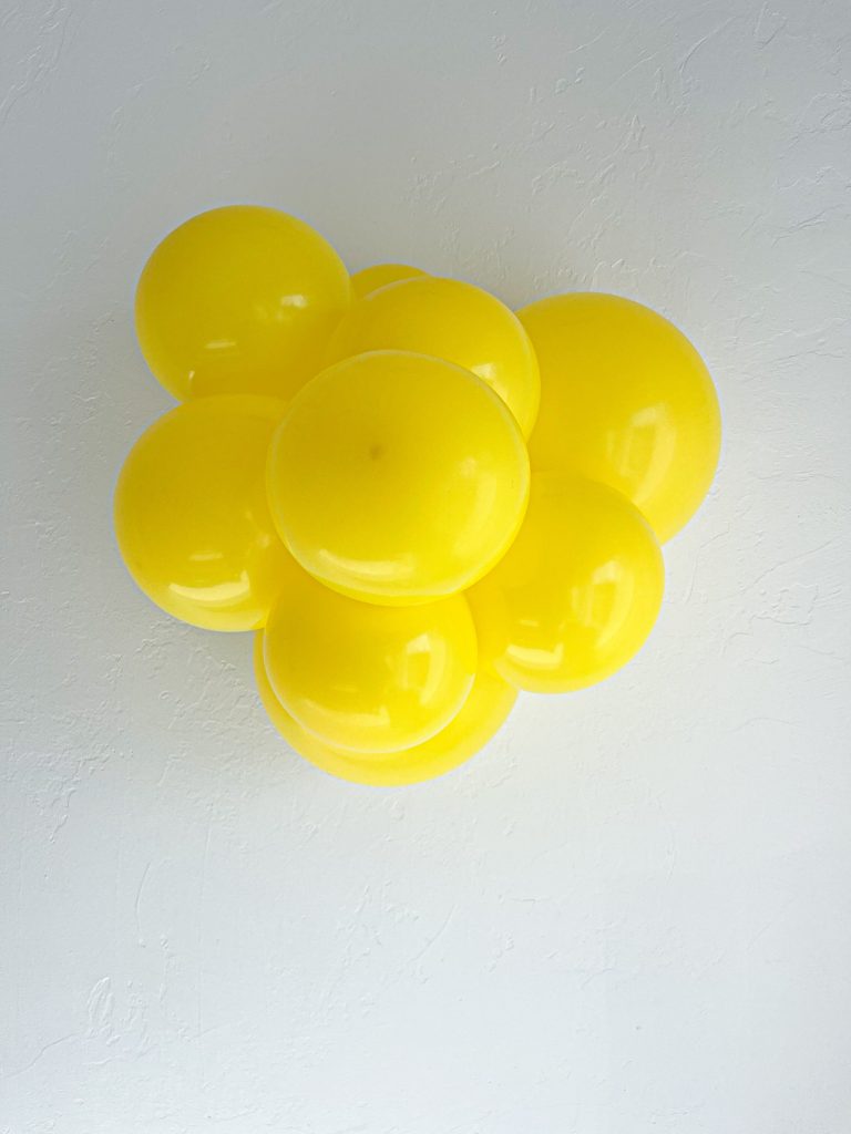 Tuftex Yellow latex balloon color cluster showing the shade across multiple balloon sizes