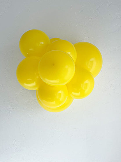 Tuftex Yellow latex balloon color cluster showing the shade across multiple balloon sizes