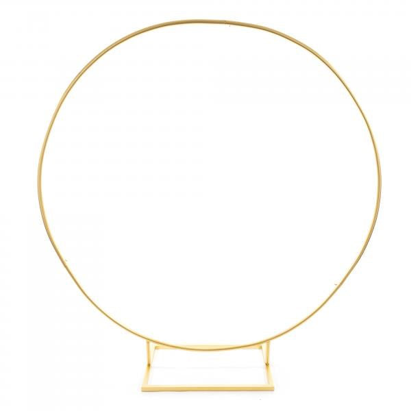 Gold metal arch circle stand with round tubes and square base, 84 inches tall.