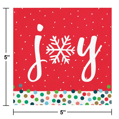 Red square beverage napkin with white "joy" text featuring a snowflake as the "o" and a multicolored polka dot border at the