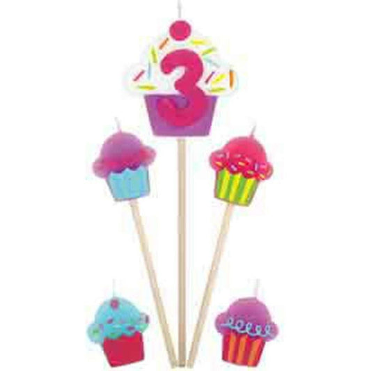 Cupcake pick candles with colorful frosting and sprinkles, featuring a large number 3 candle in pink.